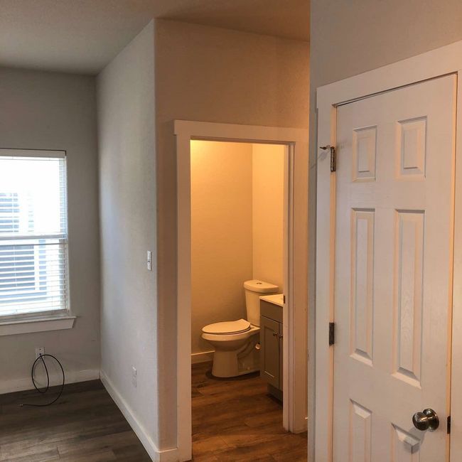 Bathroom featuring wood finished floors, vanity, toilet, and baseboards | Image 8