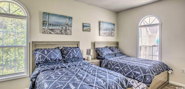 Carpeted bedroom with baseboards | Image 16