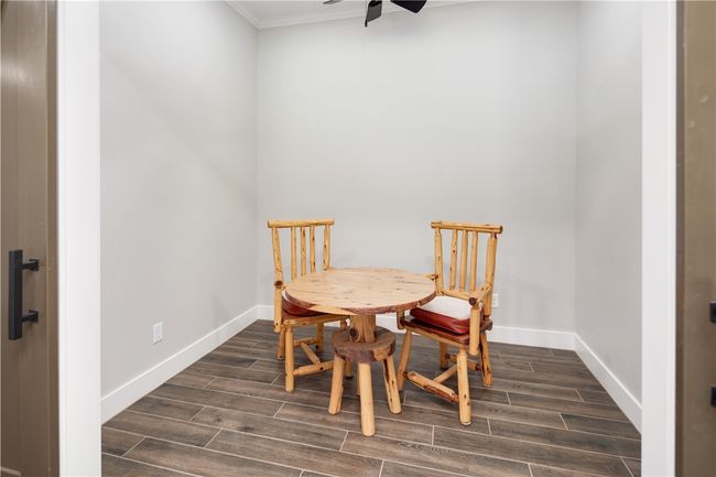 Dining space featuring a ceiling fan, crown molding, and dark wood-type flooring | Image 9