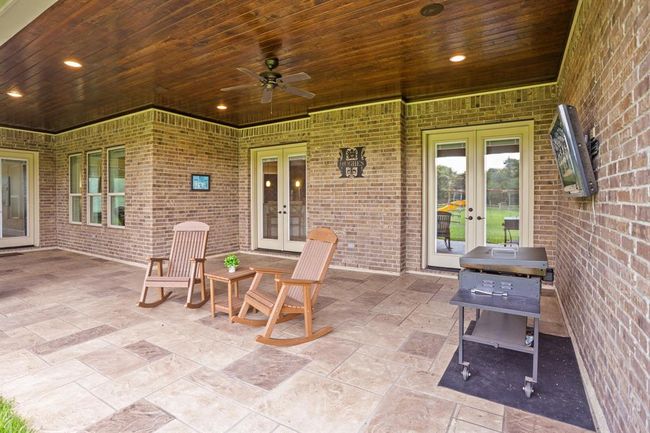 This expansive Back Patio can be accessed from both the Living Room and Game Room, making it easy to entertain both indoors and out. This is the perfect place to put a large table and chairs for outdoor dining on beautiful days. There is also plenty of room to add a summer kitchen later down the road if desired. | Image 41