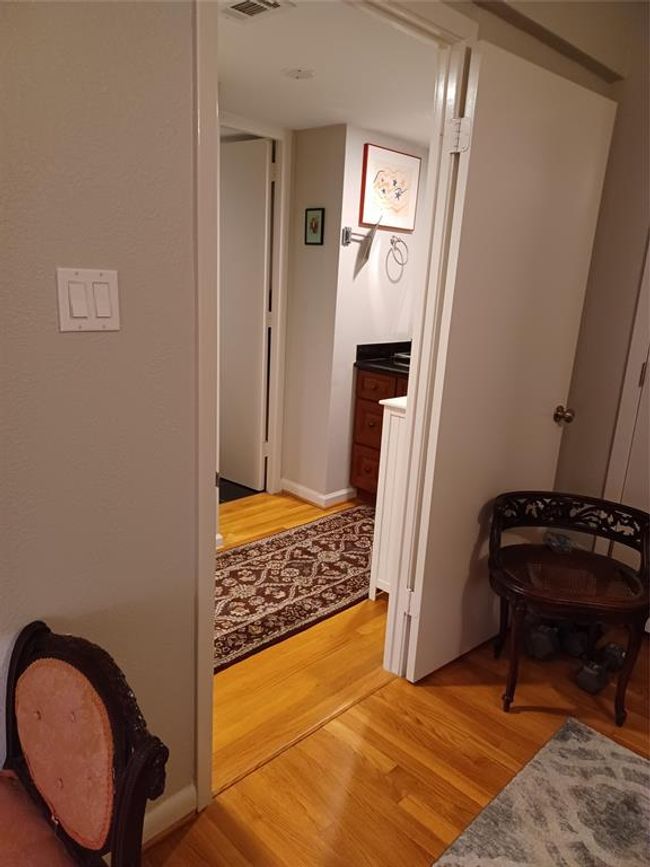 Standing at the bedroom entry door looking straight in. Behind the drapes is a sliding glass door out to the deck. | Image 19