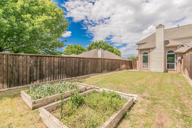 View of yard featuring a vegetable garden and a fenced backyard | Image 38