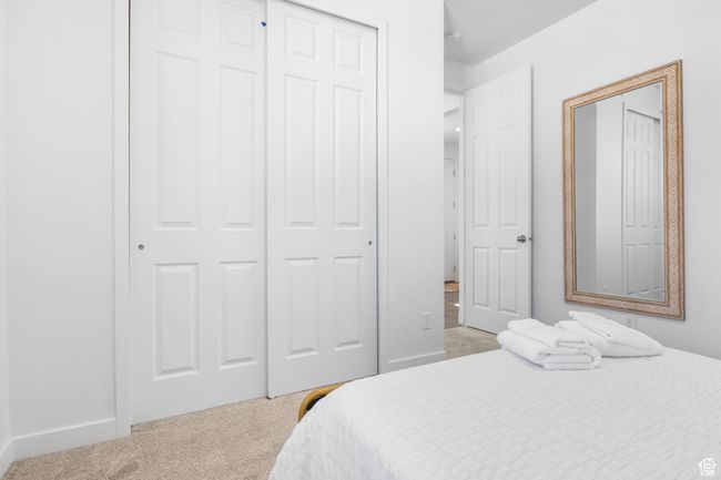 Bedroom featuring baseboards, a closet, and light colored carpet | Image 17