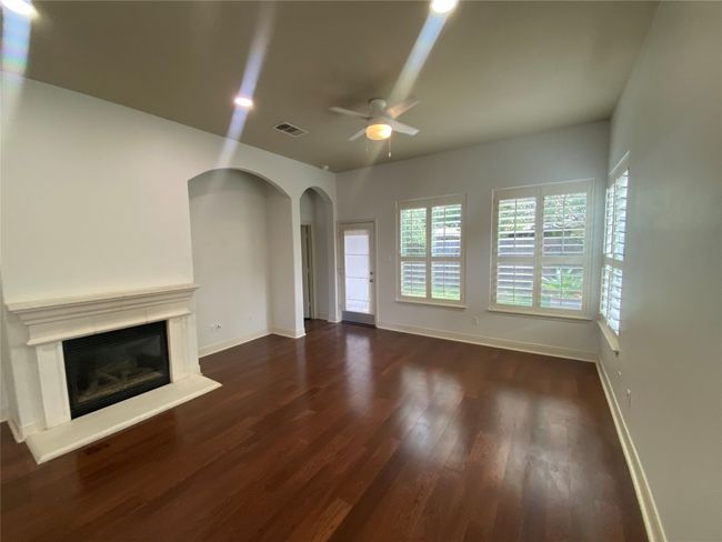 Large open living room with fireplace and recessed lighting | Image 13