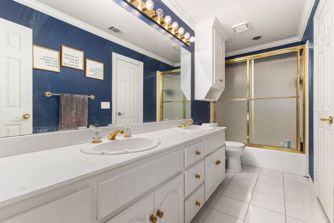 Full bathroom featuring ornamental molding, tile patterned flooring, and a sink | Image 27