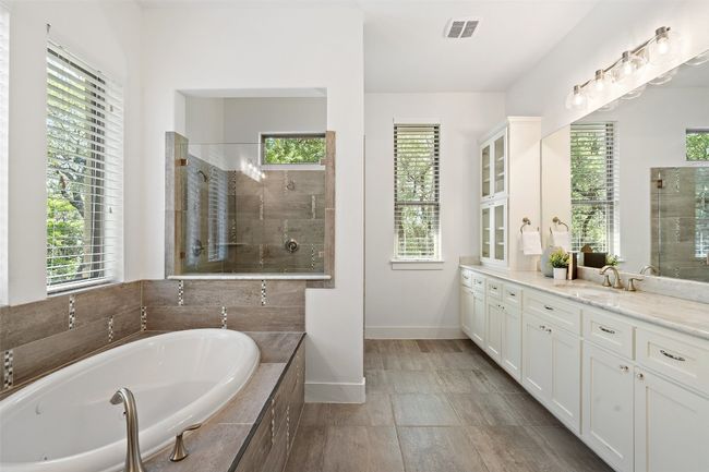 Bathroom with vanity, a garden tub, and a tile shower | Image 18