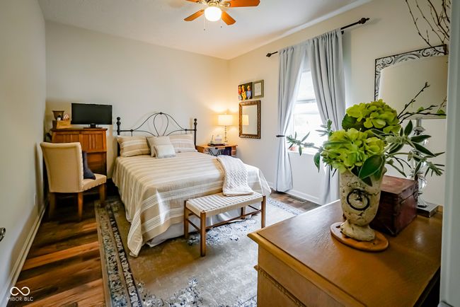 bedroom featuring wood finished floors, baseboards, and a ceiling fan | Image 19