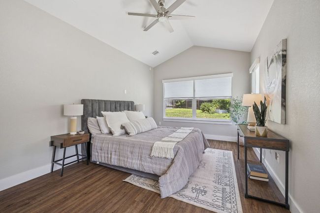 Bedroom featuring vaulted ceiling, wood finished floors, and ceiling fan | Image 18