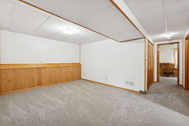 This section of the lower level could be used for a variety of purposes. Cozy TV area? Open-air office? Craft area? Playroom? | Image 21