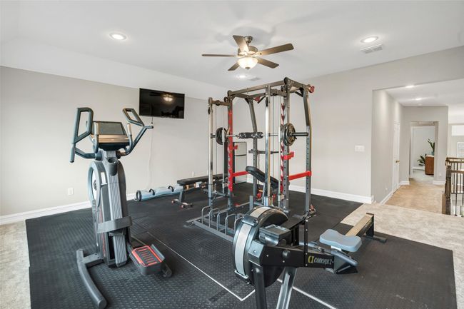 Spacious upstairs game room features carpet, recessed lighting and ceiling fan. | Image 24