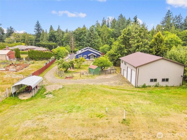 fruit trees, chicken coops, large garden with potting shed, fenced acreage, RV parking, and a creek. | Image 36