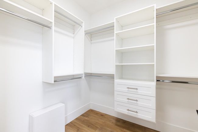 Walk in closet featuring wood finished floors | Image 31