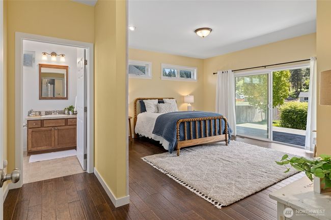 Spacious primary bedroom with en-suite, walk-in closet, and slider to the back patio. | Image 14