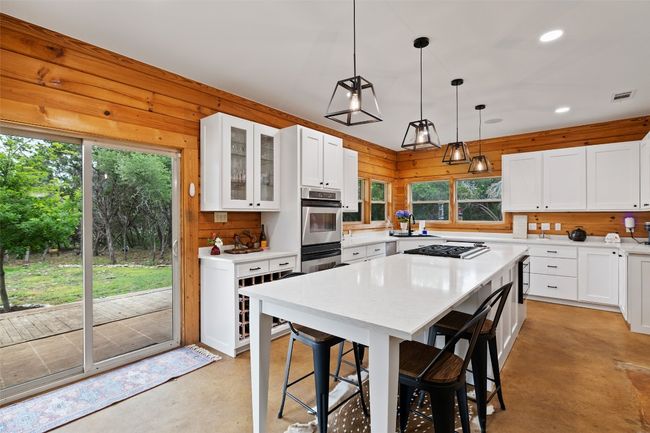 Kitchen featuring a wealth of natural light and an extended island | Image 16