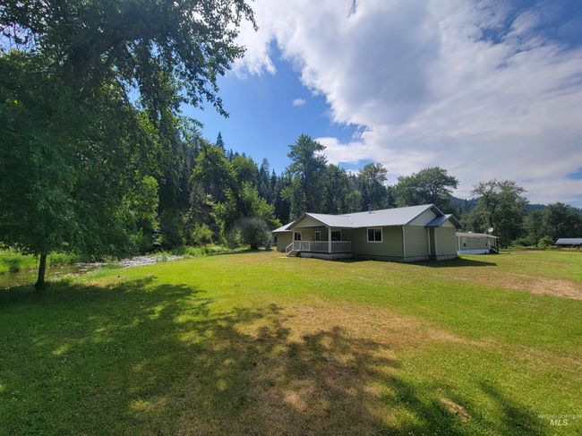View of grassy yard with a deck | Image 23