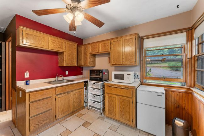 The guest house features a kitchen with ample cabinetry and space for additional appliances. | Image 18
