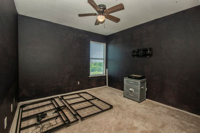 Carpeted spare room featuring a ceiling fan and baseboards | Image 13