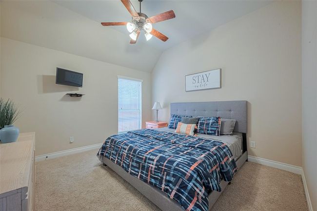 Youll find 2 full bedrooms at the front of the home - each featuring a ceiling fan and walk in closet. | Image 5