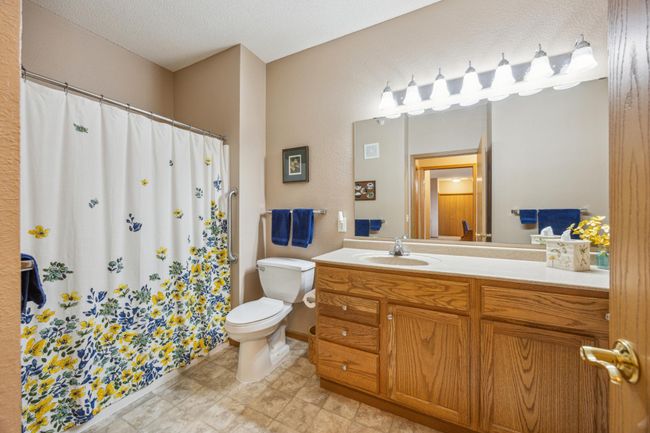 Spacious ensuite bath with an extra-large shower and a handy linen closet, providing plenty of room and storage. | Image 16
