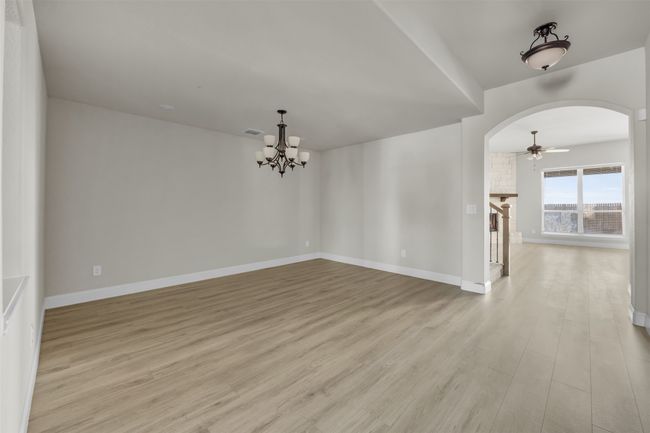 Dining room with light hardwood / wood-style floors, and an inviting chandelier | Image 13