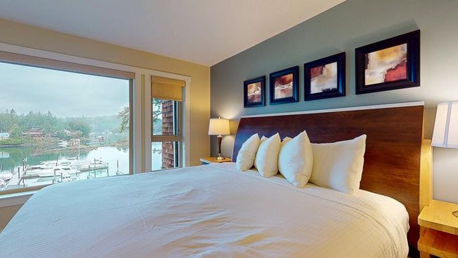 Principal bedroom featuring large windows and more ocean views | Image 21