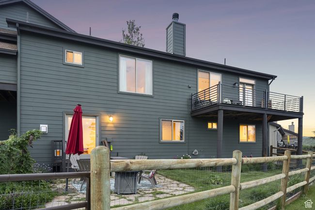 Rear view of property with a balcony, a chimney, and a patio area | Image 44