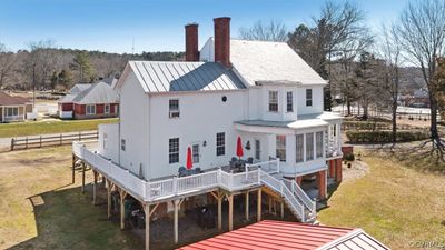 Back of house with a lawn and a wooden deck | Image 3