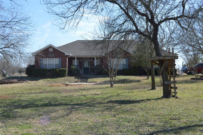 Front of house while trees are bare for the winter | Image 5