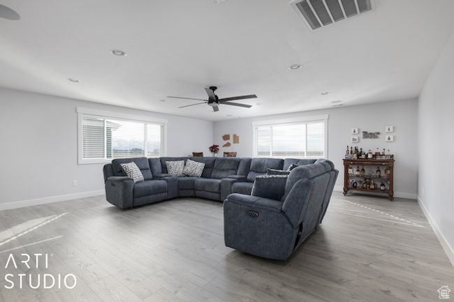 Living area with baseboards, light wood-style floors, visible vents, and ceiling fan | Image 36