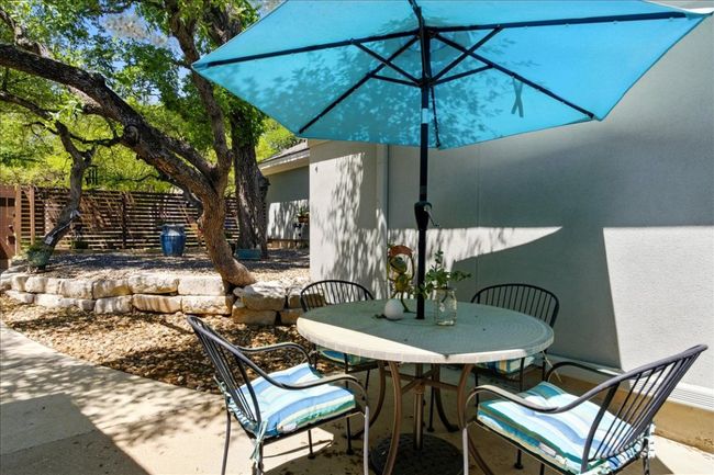 View of patio featuring fence and outdoor dining area | Image 39
