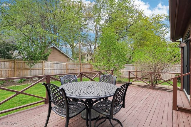 Deck with outdoor dining space and a fenced backyard | Image 36