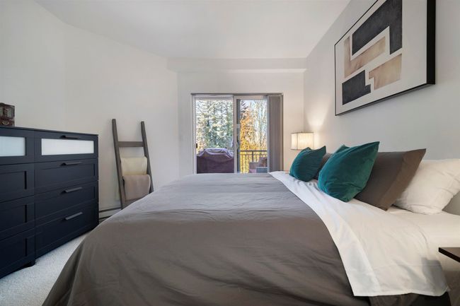 Carpeted bedroom with a baseboard radiator and access to exterior | Image 15