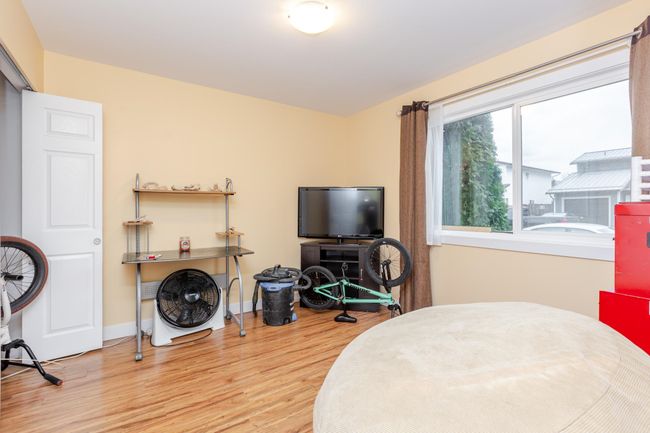 Bedroom with wood finished floors and baseboards | Image 16