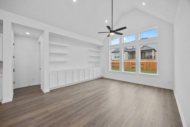 Unfurnished living room featuring ceiling fan, high vaulted ceiling, dark wood-type flooring, and recessed lighting | Image 9