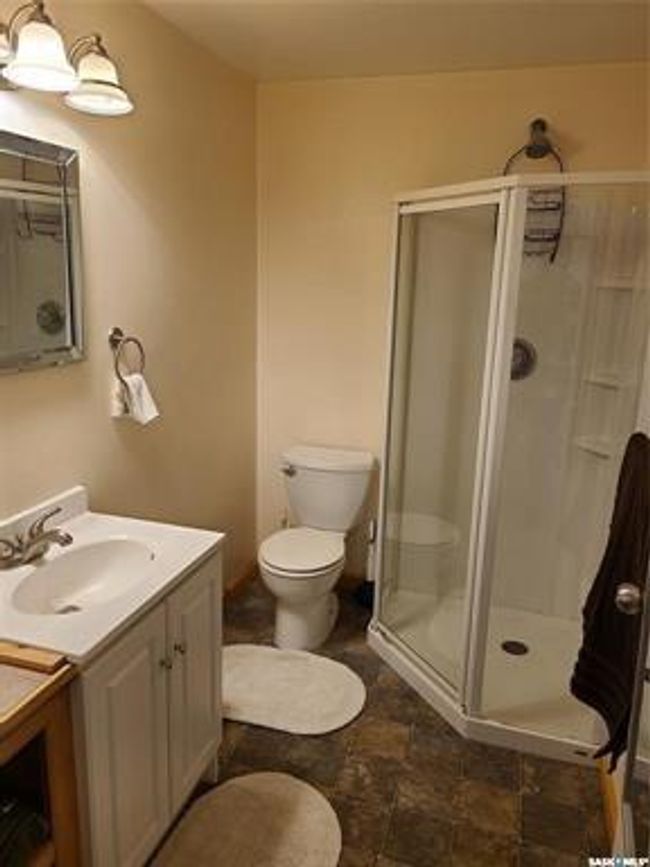 Bathroom featuring walk in shower, toilet, tile patterned floors, and vanity | Image 26