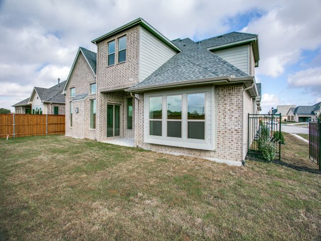 Rear view of property with roof with shingles, brick siding, and a fenced backyard | Image 25