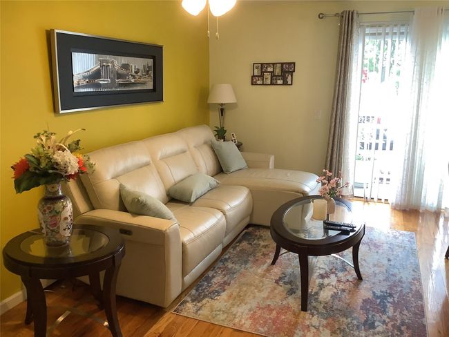 Living area featuring wood finished floors and a ceiling fan | Image 11