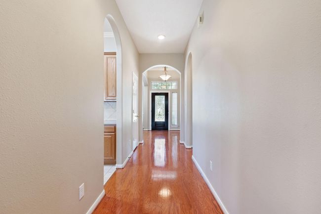 High ceilings with arched doorways let the sunlight fill every space of this lovely home | Image 7