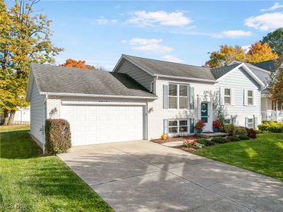 Raised ranch with a front lawn and a garage | Image 2