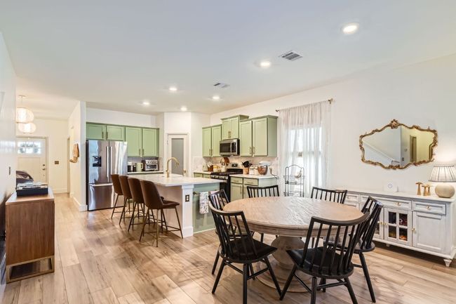 Dining space with healthy amount of natural light, light wood-style floors, and recessed lighting | Image 10