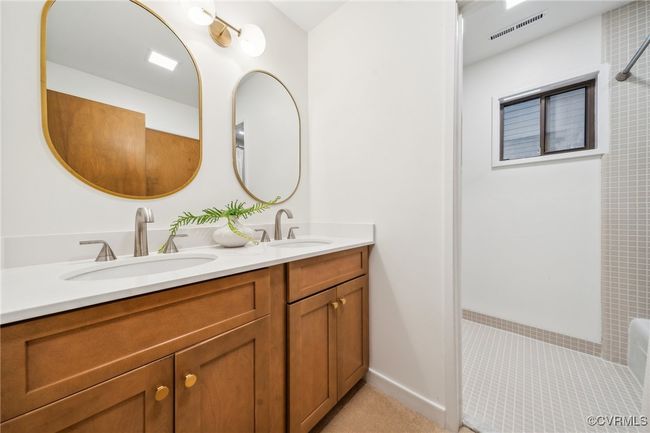 Bathroom with walk in shower, a sink, visible vents, and double vanity | Image 39