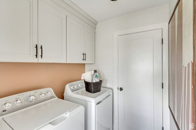 Washroom featuring washer and clothes dryer and cabinet space | Image 18