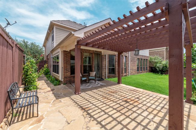 Fenced backyard featuring a pergola and a patio area | Image 39