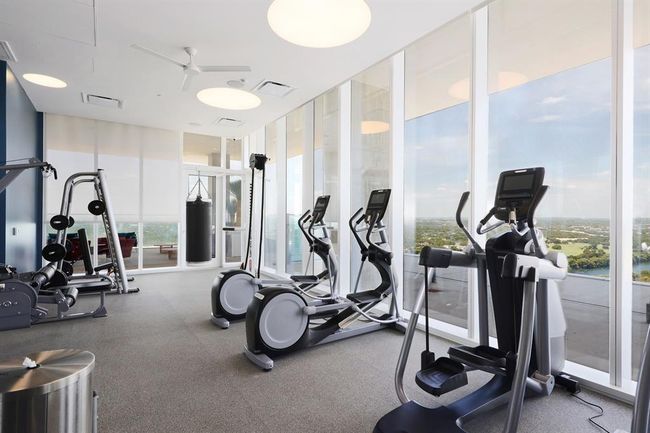 Gym featuring expansive windows, top of the line gym equipment and vies of West Austin/ Lady Bird Lake | Image 18