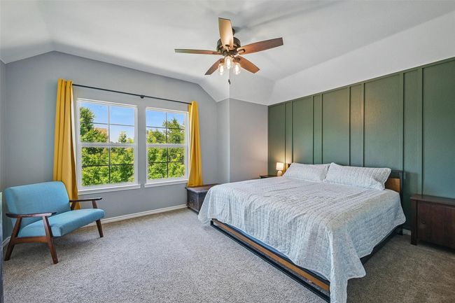 Carpeted bedroom featuring lofted ceiling, a ceiling fan, and baseboards | Image 33