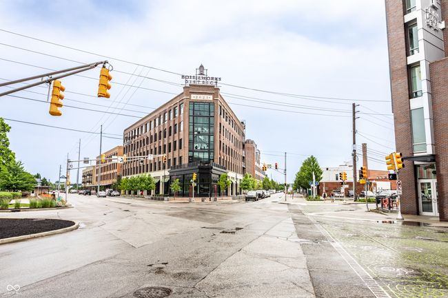 view of asphalt street with traffic lights, street lighting, curbs, traffic signs, and sidewalks | Image 41
