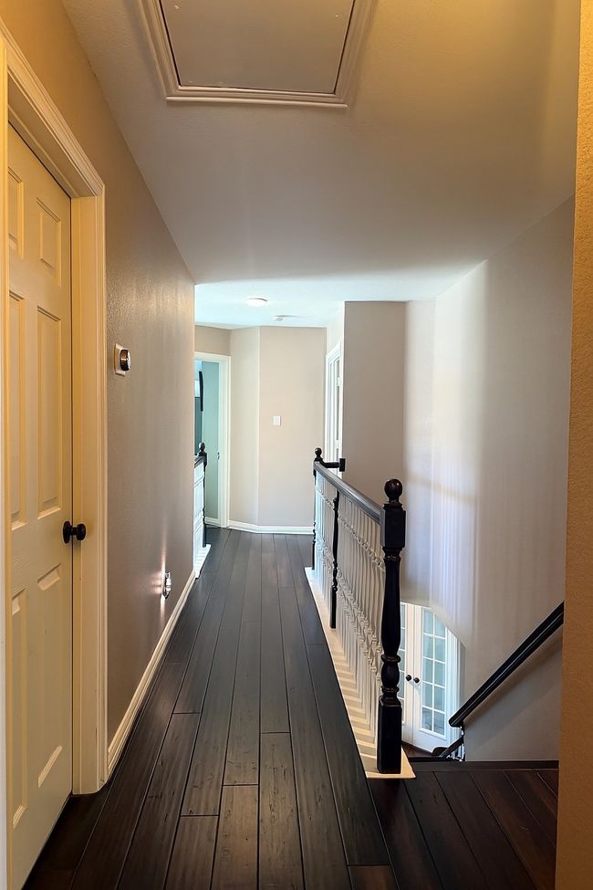 Hallway featuring an upstairs landing and dark wood-style flooring | Image 35