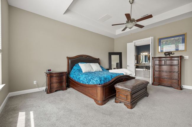 Large primary bedroom with entrance to primary bathroom | Image 21