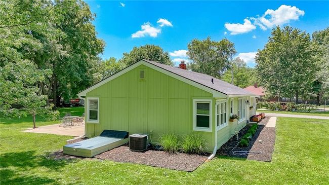 View of side of property with a patio area, a lawn, and a chimney | Image 40