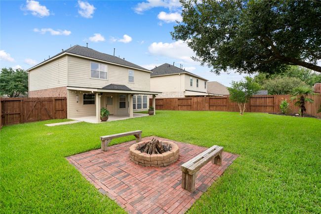 SPACIOUS back yard with a cozy fire pit area!!! Includes a 12 X 10 storage shed. | Image 37